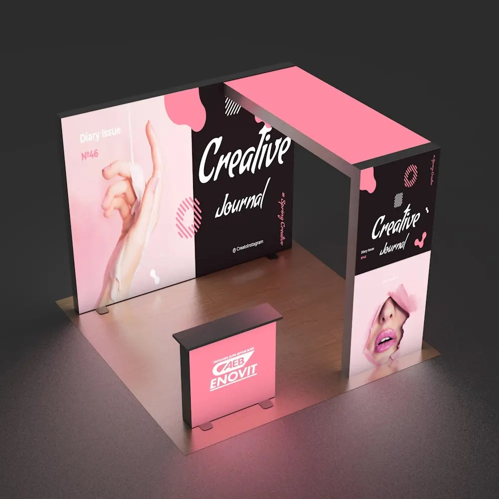 Pink and black trade show booth with 'Creative Journal' branding on a dark background