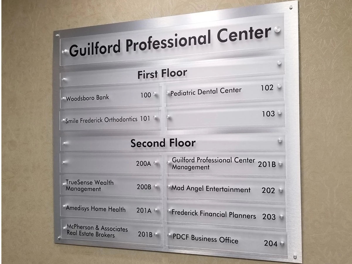 Directory sign for Guilford Professional Center with floor and room numbers.