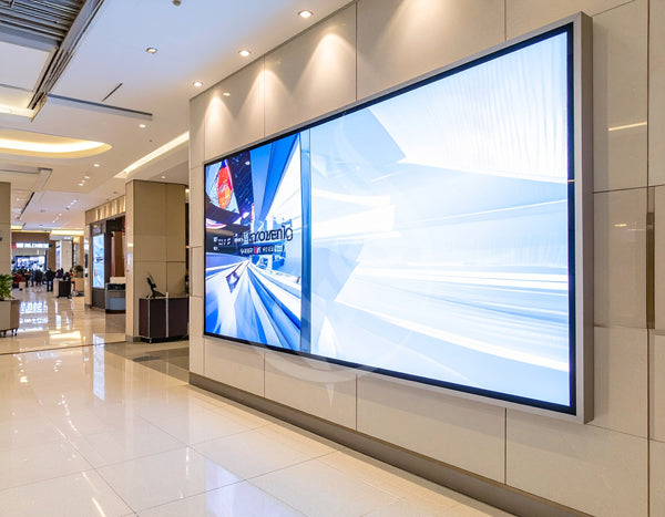 Large digital display screen on a wall in a modern indoor setting