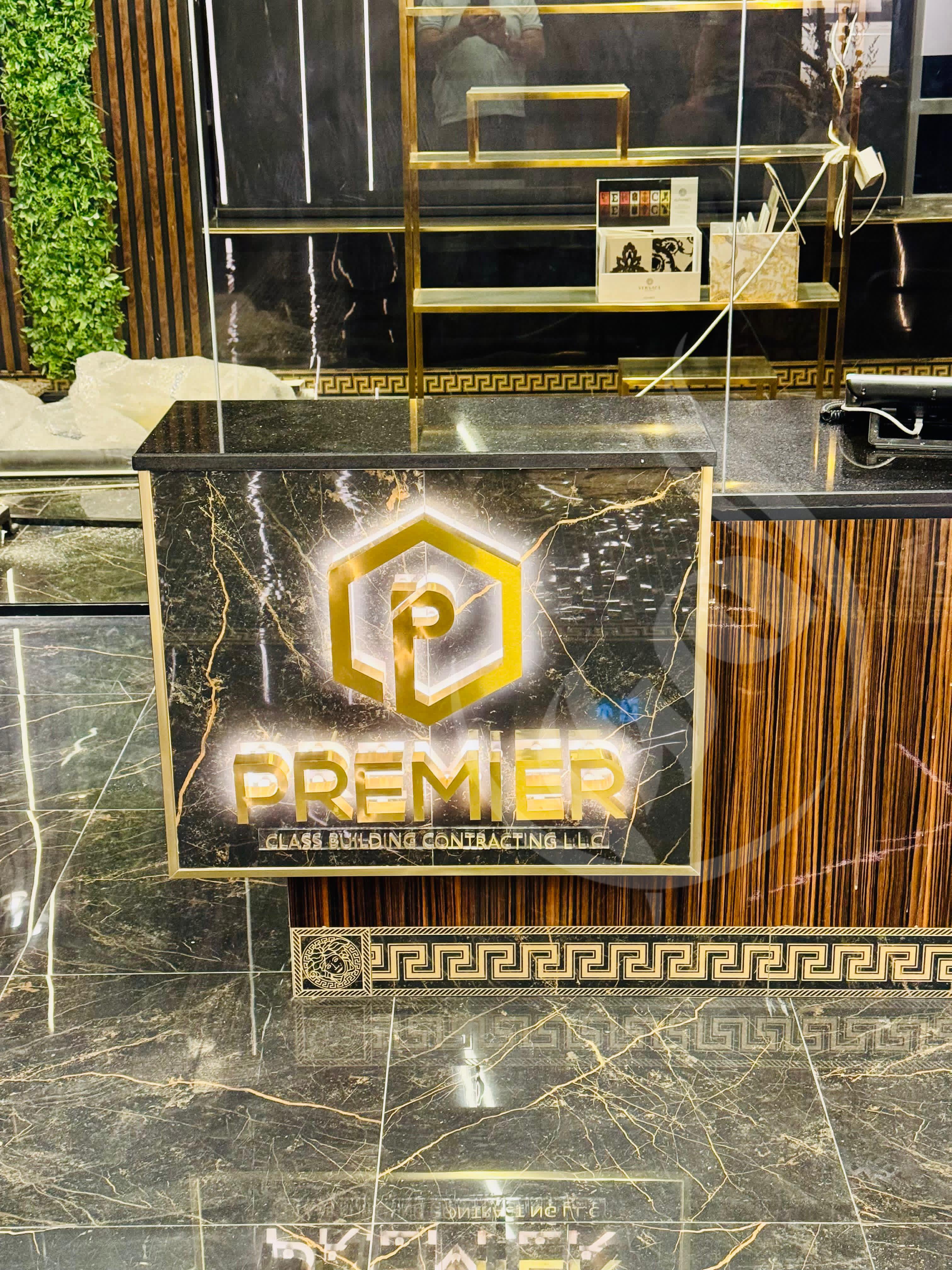 Decorative reception desk with 'Premier' logo and marble finish