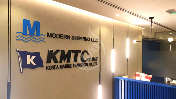 Modern Shipping LLC and KMTC Korea Marine Transport Co., Ltd. logos on a wall.