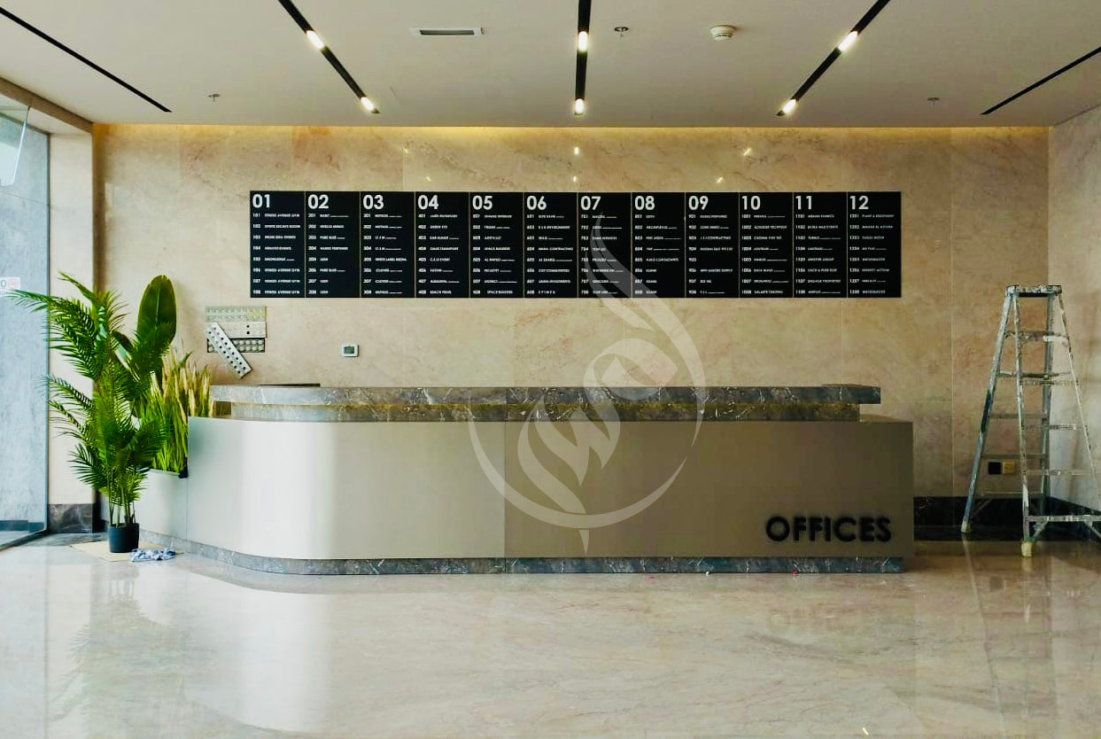 Modern office reception area with a large nameplate on the wall.