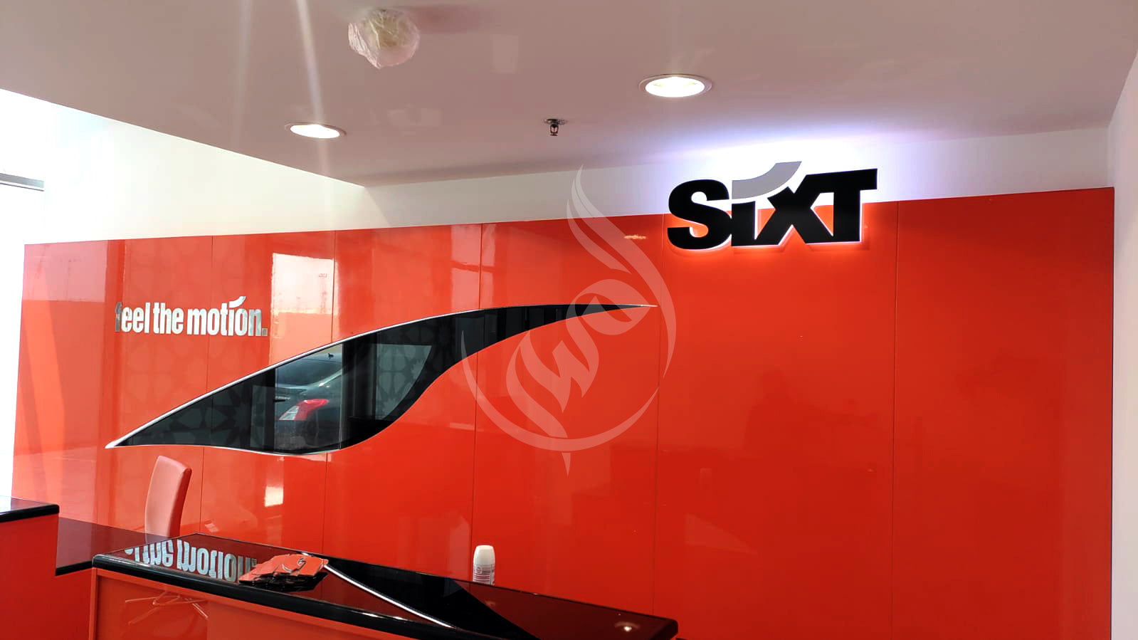 Sixt office interior with red wall and logo