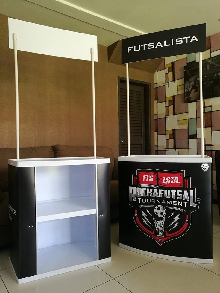 Futsal tournament booth with branding and promotional graphics.