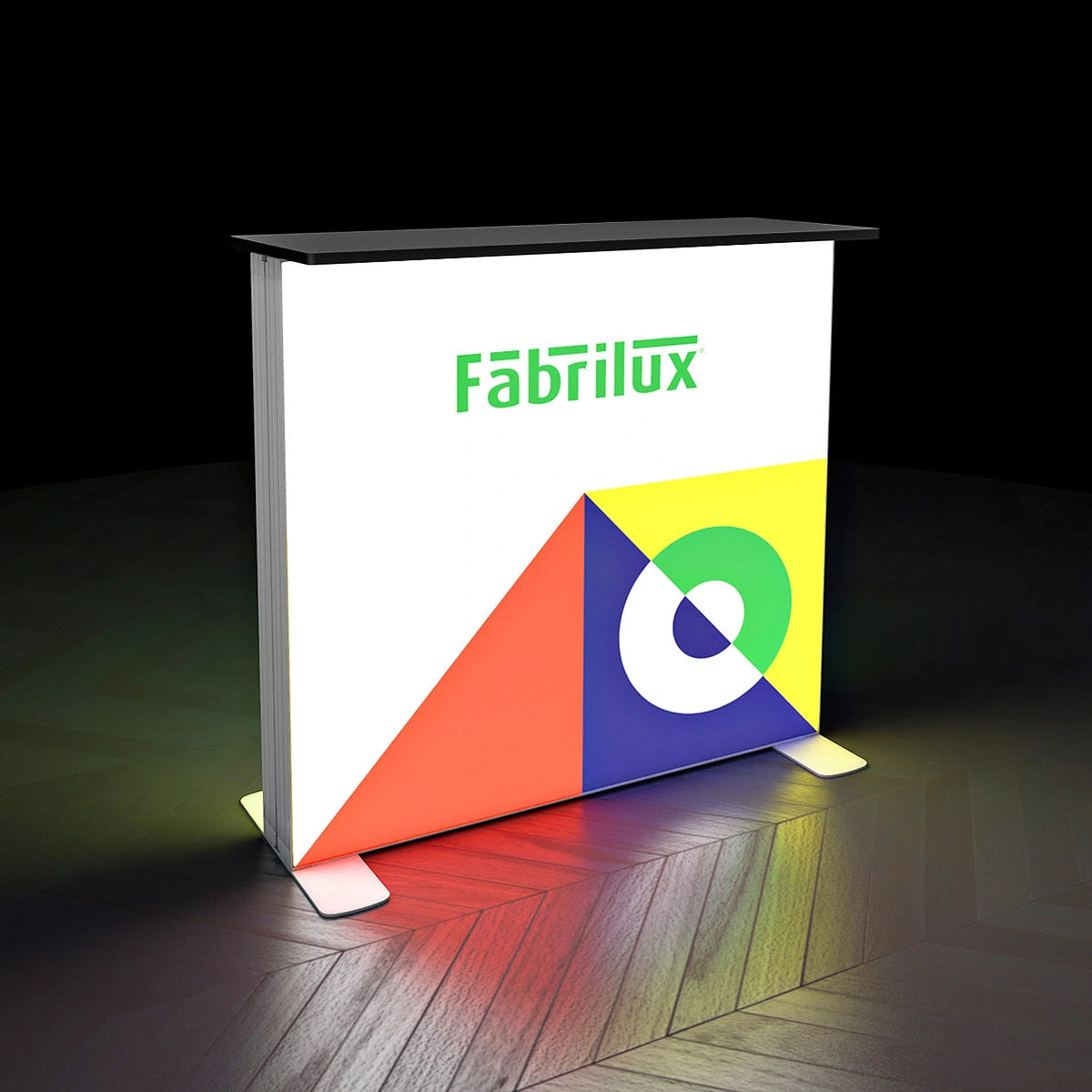 Fabricated display stand with colorful geometric design and 'Fabrilux' branding on a dark background.