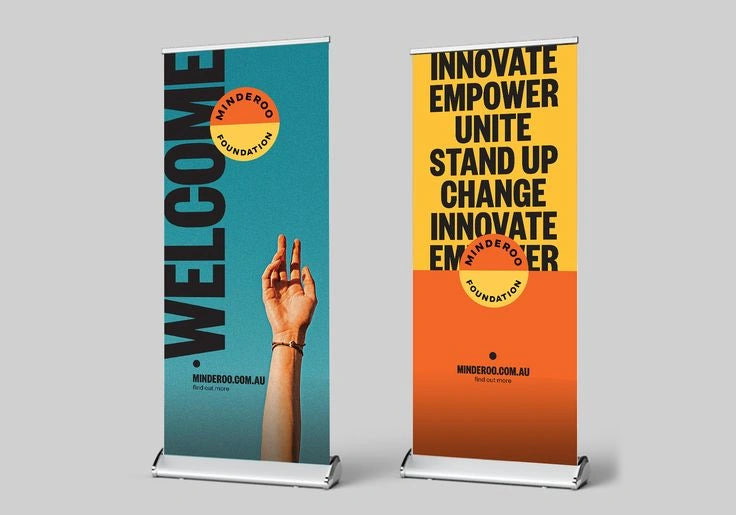 Two vertical banners with motivational text and a hand gesture on a gray background