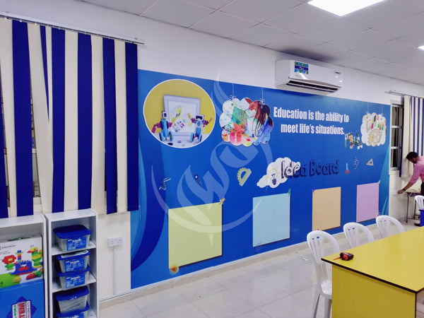 Classroom interior with educational wall decorations and furniture.