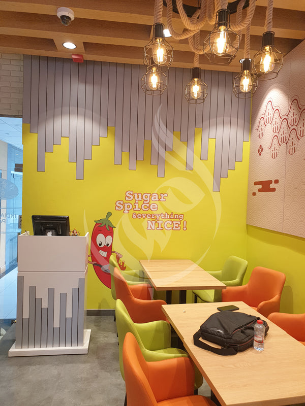Colorful interior of a restaurant with bright yellow walls and modern decor.